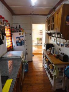 a kitchen with a counter and a refrigerator at Cabaña hippie chic en isla del Delta (Rompani) in Tigre