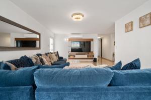 a living room with a blue couch and a tv at 4 bedroom family reserve with pool home in Dorado