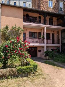 an apartment building with red roses in front of it at Aventures modernes in Roanne