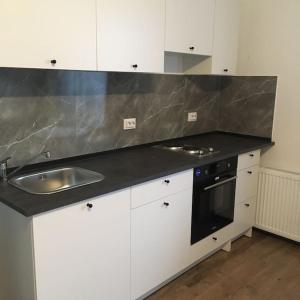 a kitchen with a sink and a counter top at Dbo-Vivo Mall Apartment in Baia Mare