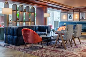 a living room with a couch and a table at Radisson Blu Royal Garden Hotel, Trondheim in Trondheim