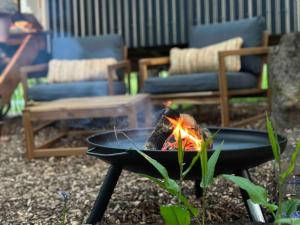 a fire pit with a fire at Cornwall Woodland Dog Friendly Shepherd's Hut in Bodmin