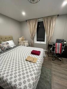 a bedroom with a bed with two bags on it at Brand New Modern unit in town! in Cochrane
