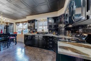 a large kitchen with black cabinets and a table at The Onyx in Walla Walla