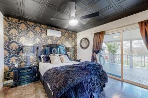 a bedroom with a blue bed and a balcony at The Onyx in Walla Walla