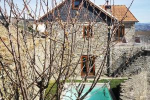 a stone house with a tree in front of it at Sobreiro's Villa in Douro Valley in Mesão Frio