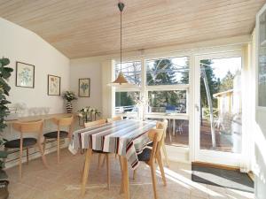 a dining room with a table and chairs at Holiday home Vig L in Vig