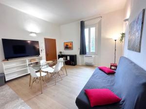 a living room with a couch and a table at La Casa di Leo Apartments in San Giorgio di Piano