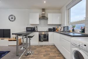 a kitchen with white cabinets and a counter top at NEW! Perfect for Families & Corporates - 3 Beds - Contact us for Better Offers! in Leeds