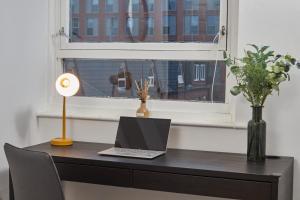 a desk with a laptop and a window at NEW! Perfect for Families & Corporates - 3 Beds - Contact us for Better Offers! in Leeds