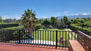 a balcony with a view of a garden at Casa Las Palmas in Ciudad Lujan de Cuyo