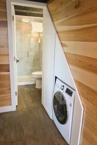 a washer and dryer in a bathroom with a toilet at Escalante Escapes Desert Willow- Loft Escape in Escalante