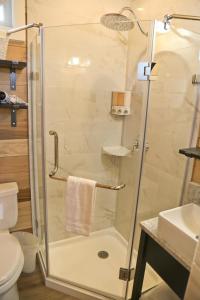 a shower with a glass door in a bathroom at Escalante Escapes Prickly Pear- Bunk Escape in Escalante
