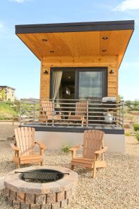 two chairs and a fire pit in front of a house at Escalante Escapes Prickly Pear- Bunk Escape in Escalante