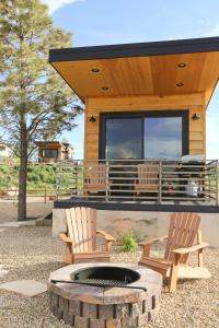 two chairs and a fire pit in front of a cabin at Escalante Escapes Tumble Weed- Bunk Escape in Escalante