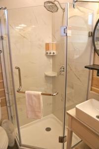 a shower with a glass door in a bathroom at Escalante Escapes Tumble Weed- Bunk Escape in Escalante