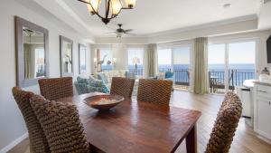 a dining room with a table and chairs and the ocean at Westwinds 4848 Su in Destin