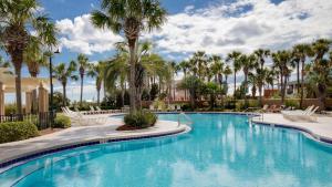 a swimming pool at the resort with palm trees at Westwinds 4848 Su in Destin