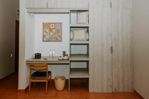 a room with a desk with a chair and a shelf at Monteverde Boutique Hotel in Pacasmayo