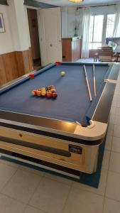 a pool table with balls and cue sticks on it at Beautiful Villa with huge private pool and vineyard view in Valencia