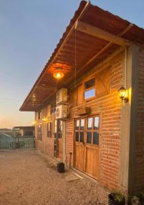 a brick building with a large door on it at MARIBAO in Playas