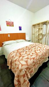 a bedroom with a large bed in a room at Pousada Mar & Sol in Fortaleza