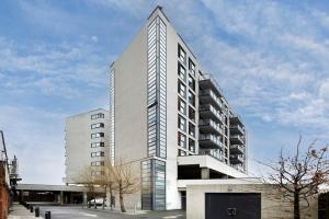 a tall white building with a triangular top at Cozy and modern 1BR flat in Enfield in Enfield