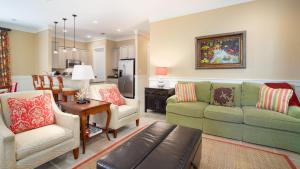 a living room with two couches and a kitchen at Bungalos 2441 in Destin