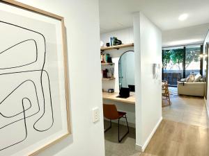 a living room with a drawing on the wall at Luxury 1 BR Apartment in Randwick- Walk to hospital UNSW Dining W parking and lift and AC in Sydney