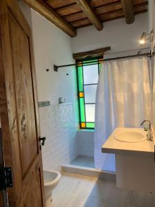 a bathroom with a sink and a toilet and a window at Casa en La Comarca in San Javier