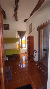 a living room with a green couch and a window at Hostal Sonchek in San Pedro de Atacama
