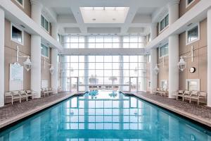 a swimming pool in a building with a large window at Majestic Sun 414B in Destin