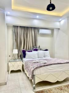 a bedroom with a large bed and a window at Alexandria Luxury Apartments Sporting Direct Sea View in Alexandria
