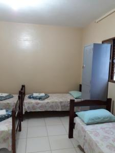Una cama o camas en una habitación de Pousada Albergue Kafundó