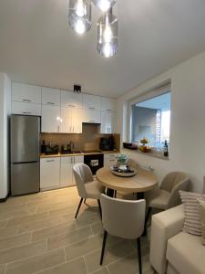 a kitchen and living room with a table and chairs at ST TOWER Apartament in Rzeszów