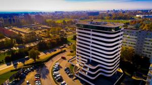 a tall building in a city with a parking lot at ST TOWER Apartament in Rzeszów