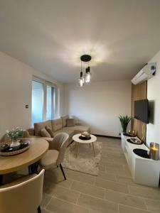 a living room with a couch and a table at ST TOWER Apartament in Rzeszów