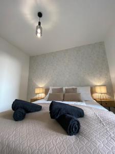 a bedroom with a large bed with blue towels on it at ST TOWER Apartament in Rzeszów
