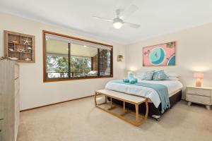 a bedroom with a bed and a window at Aqua by Experience Jervis Bay in Sanctuary Point