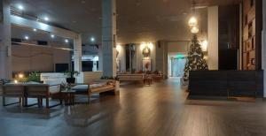 a large lobby with a christmas tree in the middle at Casa de Guapo - AYALA Serin East Taal View Condo in Tagaytay