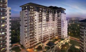 a tall building with lights on in a city at Casa de Guapo - AYALA Serin East Taal View Condo in Tagaytay