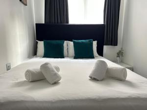 a bedroom with a bed with two towels on it at The Dome in London