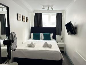 a bedroom with a bed with two towels on it at The Dome in London