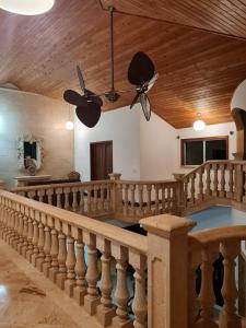 a large room with a staircase and a ceiling at Beach view villa in Long Swamp