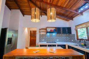 a kitchen with a wooden table in the middle at Curiol Boutique Hotel & Lounge in Potrero
