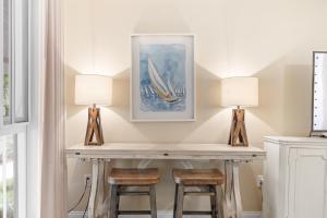 a desk with two lamps and two stools at Grand Sandestin 2210 in Destin