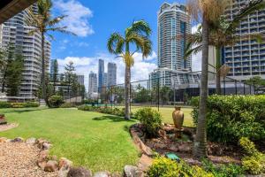 a park with palm trees and buildings in the background at Focus Apartments With Ocean Views in Gold Coast