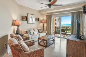 a living room with a couch and a tv at Westwinds 4740 in Destin