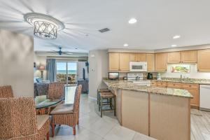 a kitchen and dining room with a table and chairs at Westwinds 4740 in Destin