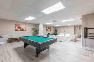 a large room with a pool table in it at Flamboyant 1BR Near EWR w/ Gym in Newark